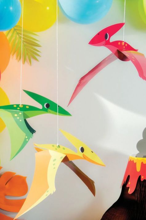 Hang a bunch of these pterodactyl dinosaurs from your ceiling, mantelpiece, or entryway to decorate your party and have your guests feel like they are really among dinosaurs. They are so bright and colorful and are a wonderful dinosaur party decoration. See more party ideas and share yours at CatchMyParty.com Dinosaur Classroom Ideas, Dinosaur Decorations For Classroom, Dinosaur Decor Diy, Dinosaur Photo Booth, Festa Rock Roll, Dino Decorations, Dinosaur Decorations, Dino Party Decorations, Dinosaur Classroom