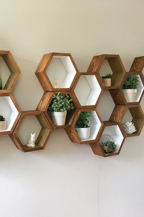 "If you're looking for a way to beautifully display your favourite picture frames, books, trinkets or plants, this is exactly what you need. 🪵 🪵 They are sold in sets of three (3) [Hexagonal shaped wall shelves.] BUT I can make any custom order to your liking! The post offers three (3) shelves In a standard size, you can message me for custom requests like 18x16x5\". Size (approximately): 14\" width x 12\" hight x 4.5\" deep  🎨 Most popular order is 6 Hexagons - American Walnut stain with 2-3 Hexagonal Shelves, Mid Century Shelves, Hexagon Wall Shelf, Decoration Hall, Hiasan Bilik Tidur, Honeycomb Shelves, Geometric Shelves, Architectural Art, Hexagon Shelves