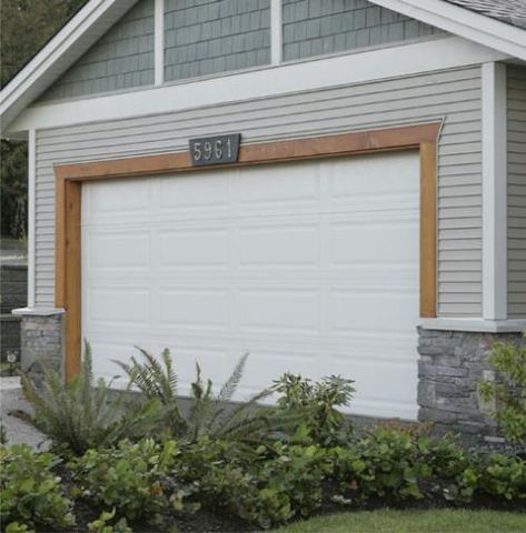 stain wood trim around garage door Wood Door And Garage Door, Wood Trim Around Garage Door, Cedar Shakes Around Front Door, Lake House Garage Doors, Wood Trim Garage Door, Wood Accent Above Garage Door, Wreath Above Garage Door, Trim Around Garage Doors, Cedar Trim Around Garage Door