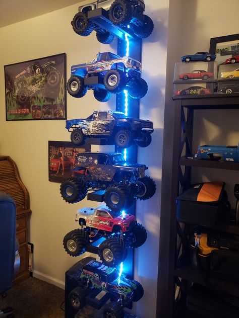 Monster Truck Garage Diy, Rc Car Storage Ideas Diy, Monster Truck Wall Storage, Remote Control Car Storage, Kids Car Room Ideas, Little Man Cave Toddler Room, Rc Storage Ideas, Monster Truck Toy Storage, Monster Truck Bedroom Decor