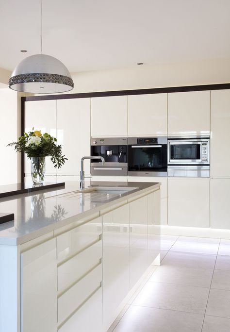 Sleek lines with this white gloss handleless kitchen and Silestone worktops. White Gloss Handless Kitchen, Modern White Gloss Kitchen, Push To Open Kitchen Cabinets, White Kitchen Worktop Ideas, Push Open Kitchen Cabinets, Gloss Kitchen Cupboards, White Kitchen Diner, White Handless Kitchen, White Gloss Kitchen Ideas