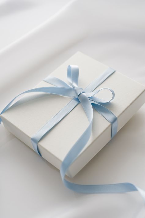 A blue satin bow wrapped around a white box is the chicest way to wrap a gift for any occasion. Baby Blue And White Aesthetic, Baby Blue Aesthetic, Light Blue Aesthetic, Good Color Combinations, Bleu Pastel, Blue Aesthetic Pastel, Cat Mom Gifts, Blue Gift, Mua Sắm