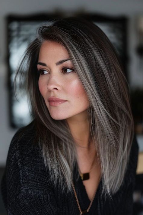 Get ready to embrace your natural greys with our collection of chic ideas for black hair with silver highlights. From the subtle silver streaks you see here to chunky white highlights, we've got a ton of gorgeous gray blending inspo on the blog. Click the pin to check it out now and pin your favorite ideas! Purple With Grey Hair, Short Brown Hair With Grey Highlights, Grey Front Highlights On Dark Hair, Slightly Highlighted Brown Hair, Extra Long Bob Hairstyles, Medium Length Hair Styles Women Over 50, Face Framing Silver Highlights, Dark Grey Hair Color Ideas, Gray And Brunette Hair