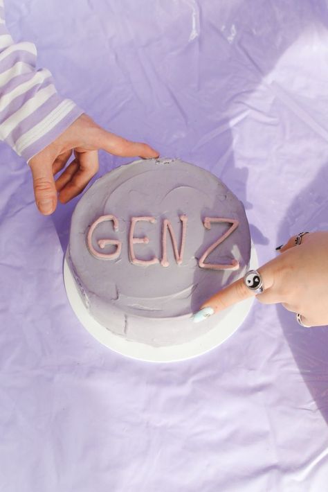 lavender purple violet gen z cake with yin and yang ring and people pointing hands to the cake. #generationz International Youth Day, Generation Z, Gen Z, Photo Memories, Personal Injury, Yin Yang, Personal Branding, Mood Boards, Mood Board