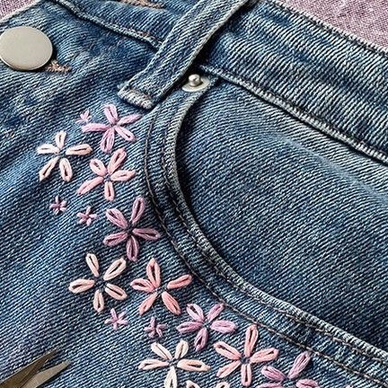 Lia Griffith on Instagram: "These Flower Embroidered Jeans are a great way to give you or your kiddos’ favorite beat-up old jeans a spring glow-up! Using our trusty lazy daisy stitch, we’ll have you feeling “flower-powerful” in no time. https://liagriffith.com/flower-embroidered-jeans/ This beginner-friendly project is perfect for those cozy January afternoons when you’re yearning for a creative escape. #DIYJeans #UpcycledFashion #EmbroideryCraft #HandmadeJeans #SustainableStyle #FlowerEmbroidery #CraftyFashion #CustomDenim #FashionUpcycle #DenimCraft #DIYStyle #EcoFashion #JeansRevamp #CreativeStitching #UpcycledClothing #EmbroideryArt #DIYFashionista #SewMuchStyle #FashionCrafting #GreenFashion #MadeWithLia" Flower Patches On Jeans, Embroidery Flowers Beginner, Jean Pocket Embroidery Flowers, Embroidery On White Jeans, Embroidered Jeans Pocket Flowers, Jeans Embroidery Tutorial, Diy Embroidered Flowers, Embroidering On Jeans, Embroidered Hem Jeans