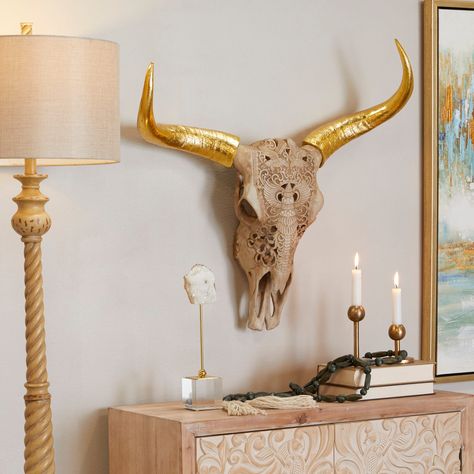 "Get the Brown Polystone Carved Skull Cow Wall Decor 28\" x 7\" x 28\" at Michaels. com. Give your home a personalize touch and bring your creative vision to life. Decorate with ease with our eclectic range of home decor. Decorate with fun with Iris And Ivory A boho inspired style that exudes creativity with a free-spirited design. Decorative animal skull is a creative mold of polystone. Bull skull features an off-white shaded head and a metallic gold horn. Animal-inspired tribal carvings line t Cow Wall Decor, Cow Skull Decor, Botanical Display, Skull Wall Decor, Real Skull, Buffalo Skull, Carved Skull, Nature Wall Decor, Bohemian Wall Decor