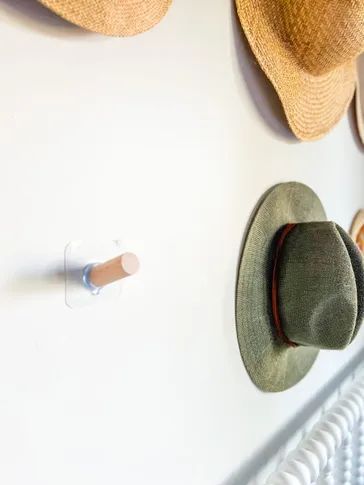 Adding hooks to our wall to complete the hat display. Vintage Hat Hanger, Las Vegas, Hooks For Hats Wall, Ways To Display Hats On Wall, Beach Hat Wall Decor, Wide Brim Hat Storage, Hat Wall Hooks, How To Hang Baseball Hats On Wall, Hat Hook Ideas