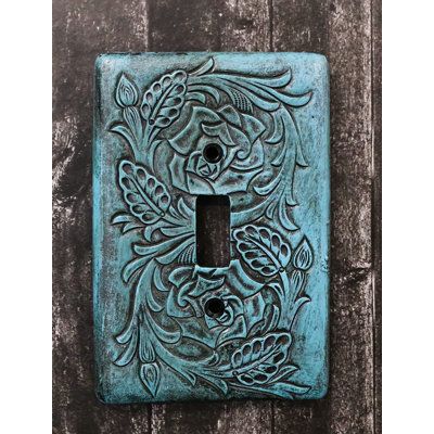 These Western turquoise tooled floral blossoms wall electrical cover plates. They fit standard wall receptacles. Each plate weighs about 5 ounces. | Ebros Gift Tooled Scrollwork 1-Gang Toggle Light Switch Wall Plate in Blue / Green | 5.25 H x 3.5 W x 0.5 D in | Wayfair Ceramic Light Switch, Clay Inspo, Turquoise Walls, Western Turquoise, Concrete Candle, 3d Hand, Toggle Light Switch, Turquoise Background, Ceramic Light