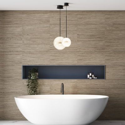 Replicating a wood look, our Woodstrip Ceramic Wall Tile provides decorative appeal that adapts to a variety of stylistic contexts, making it a great choice for your space. With its non-vitreous features, this rectangle tile is an ideal selection for indoor installations, including bathrooms, backsplashes, showers, hallways and fireplace facades. This tile is a perfect choice on its own or paired with other products in the Woodstrip Collection. Tile is the better choice for your space. This tile Contemporary Spa Bathroom, Feature Wall Behind Bathtub, Tile On Walls In Bathroom, Tub Surround Tile Designs, Shower Cutout Shelf, Ledge In Shower Wall, Bathroom Tile That Looks Like Wood, Master Shower Tile Ideas Modern, Wood Look Shower Walls