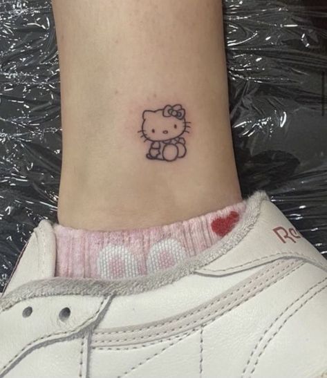 Cute Small Hello Kitty Tattoos, Cute Hello Kitty Tattoo Ideas, Hello Kitty Strawberry Tattoo, Minimalist Tattoo Matching, Cartoon Tattoos Women, Sanrio Tatoos, Small Tattoo On Hip, Tatuajes Hello Kitty, Sanrio Tattoo Small