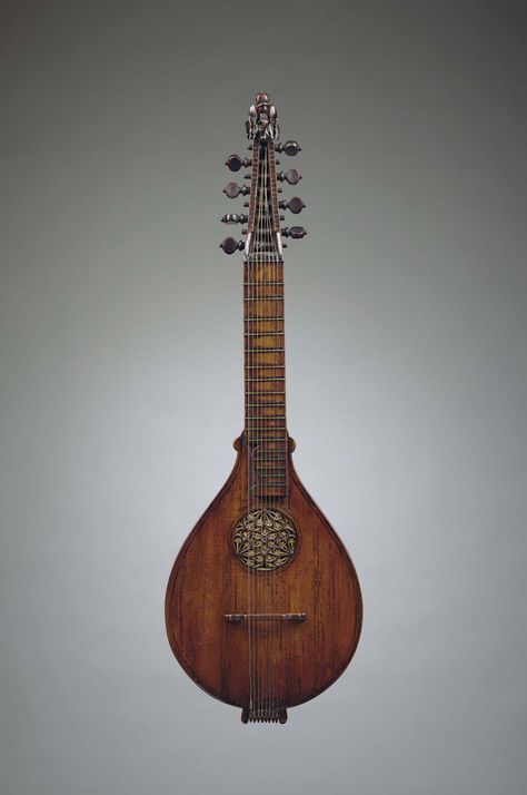English cittern, circa 1600. A stringed instrument dating from the Renaissance, descended from the Medieval citole, or citole. Its flat-back design was simpler and cheaper to construct than the lute. It was also easier to play, smaller, less delicate and more portable. Played by all classes, the cittern was a premier instrument of casual music making much as is the guitar today. Cittern Instrument, Medieval Musical Instruments, Lute Design, Medieval Lute, Lute Instrument, Medieval Instruments, Old Musical Instruments, Lucas Lima, Medieval Music