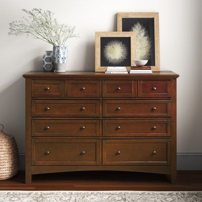 Give your bedroom or guest room an instant upgrade with the rustic style of this 8-drawer double dresser. It’s made of kiln-dried engineered wood. Framed drawer fronts and sides, sleek hardware, and molding trim offer a traditional look. This dresser’s five removable drawers offer plenty of room for clothing or spare linens. It's 60” wide and 19” deep top is ideal for a lamp and your favorite decorative items. Plus, an anti-tip device is included for added stability. Color: Warm Cherry | Lark Ma Cherry Room Aesthetic, Wardrobe In Living Room, Double Dresser In Bedroom, Draws Bedroom, Large Bedroom Dresser, Bedroom Decor Items, Cherry Wood Dresser, Traditional Chest Of Drawers, Dresser Top Decor