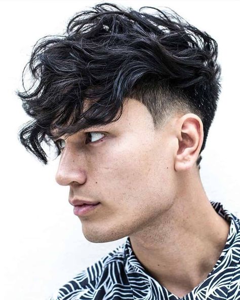 Men's long wavy hair with low taper fade and heavy fringe haircut. This hairstyle first appeared in the article: Low Taper Fade Haircut: What It Is & The Best Styles For 2022, on MensFlair.com Low Taper Haircut, Fringe Bangs Hairstyles, Hair Types Men, Low Taper Fade Haircut, Undercut Curly Hair, Low Taper, Best Fade Haircuts, Curly Undercut, Black Wavy Hair