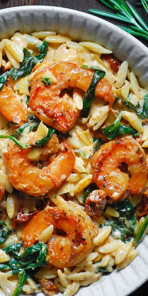 Creamy Tuscan Shrimp Pasta (Orzo) with Sun-Dried Tomatoes, Artichokes, and Spinach (30-Minute One-Pan Meal). Italian-inspired Autumn comfort food made with orzo pasta. This pasta dish is an easy weeknight meal to make during colder months of the year (Fall and Winter). #shrimppasta #pasta #comfortfood #creamyshrimppasta #creamypasta #orzo #orzorecipes #orzoideas #dinners #maindishes #maincourses #Italianfood #Italianrecipe Mediterranean Pasta Recipe, 1 Pan Lemon Orzo Pasta With Shrimp, Mediterranean Italian Recipes, Chicken And Shrimp Orzo, Shrimp And Pasta Recipes Easy Healthy, Shrimp And Orzo Recipes Healthy, Tuscan Shrimp Orzo, Orzo Pasta Casserole, Shrimp Orzo Asparagus Recipes