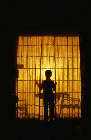 Looking at the silhouette of a child looking out an illuminated window.... Light Shining Down On Person, Person Looking Out A Window, Shadow Behind Curtain, Silhouette In Window, Looking Through Window Art, Window Light Photography, Flat Landscape, Window Silhouette, Night Window