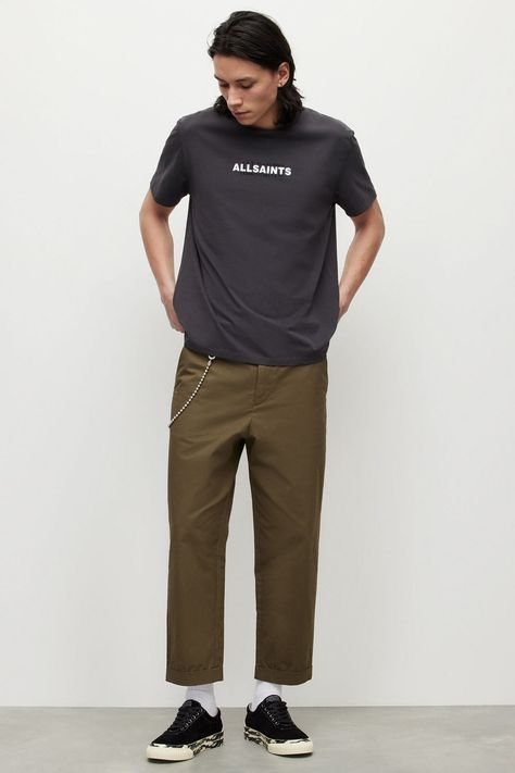 Men's khaki green cropped wide-leg chinos, black logo T-shirt, white socks, black canvas sneakers and wallet chain outfit. This outfit was included in the article: How To Wear Wide-Leg Pants: 20 Outfits That Won’t Make You Look Like A Clown, on MensFlair.com Wallet Chain Outfit, Straight Cropped Jeans Outfit, Chain Outfit, Cropped Jeans Outfit, Jeans Outfit Men, Wide Leg Pants Outfits, Brand Personality, Leg Pants Outfit, Black Cropped Pants