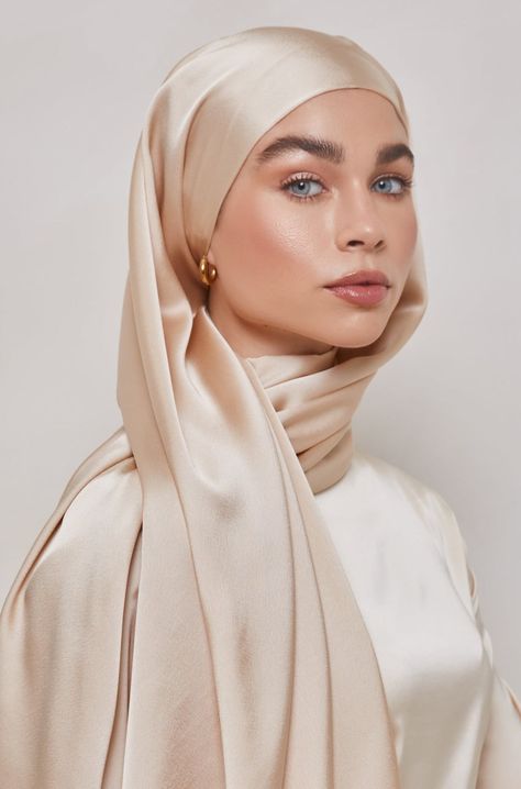 This satin hijab feature a smooth high shine satin fabric with a subtly textured backing to prevent slippage. Pair with your favorite evening attire, gold jewelry and an effortless magnet pin for a timeless look. Measurements Standard: approx. 180 cm x 70 cm (70" x 27") Petite: 180 x 45 cm (70" x 17") - this size is appropriate as a hijab for small children or for wrapping as a shawl or body coverup Material 100% Satin Polyester Hijab High Fashion, Model With Hijab, Satin Hijab Style, High Fashion Hijab, Hijabi Jewelry, Satin Hijab Tutorial, Satin Shawl Hijab, Cream Hijab, Gold Hijab