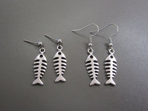 Creepy Fishbone Earrings Simple fish-bone charms hang from either little studs, or fish hook wires The fish bone earrings are made from a plated alloy, and the ear wires are made of a similar material. Surgical Steel hooks also available. Fishbone Earrings, Physical Manifestation, Creepy Earrings, Fish Skeleton, Fish Earrings, Skeleton Earrings, Fish Jewelry, Bone Earrings, Metal Fish