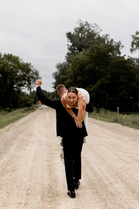 Groom walks away carrying bride over his shoulder as he celebrates with a fist in the air while bride flashes a smile and shows off her stunning wedding ring. Unique Wedding Poses, Groom Wedding Pictures, Fun Wedding Pictures, Bride Groom Poses, Groom Photoshoot, Wedding Portrait Poses, Bride Pictures, Wedding Couple Photos, Bride Groom Photos