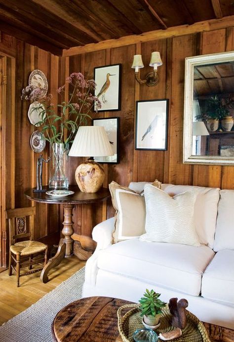 Love this tip explaining how to create a fresh, light look in an interior with dark wood paneling. (Hint: it involves white ;-) Brick Fireplace Wood Paneling, Boho Cabin Living Room, Hardboard Wall Panel Ideas, Pine Walls Living Room, Wood Burner Living Room, Moody Beach House, Wall Decor Wood Panel, Knotty Pine Rooms, Wood Paneling Living Room