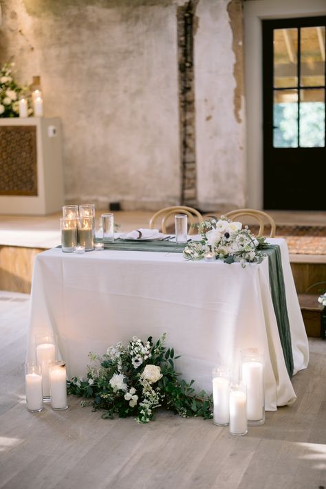 Sweetheart Head Table Wedding, White Roses With Eucalyptus Centerpieces, Eucalyptus Head Table Wedding, Wedding Floral Arrangements Sweetheart Table, Sweetheart Table Wedding Sage Green, White And Sage Centerpiece Wedding, Half Circle Sweetheart Table Wedding, Mr And Mrs Table Wedding Elegant, Greenery Background Wedding