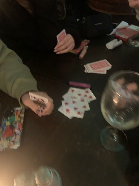 friends playing cards at a bar Card Game Astethic, Playing Cards With Friends Aesthetic, Playing Cards Aesthetic Friends, Friends Playing Cards Aesthetic, Video Games With Friends Aesthetic, Playing Cards Astethic, Card Games With Friends, Fun Activities To Do With Friends Aesthetic, Card Game Aesthetic Dark