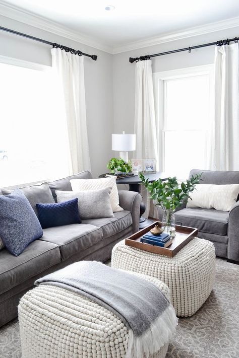 Grey Couch White Ottoman, Gray Living Room With Blue Accents, Black Hardware Living Room, White Curtains Gray Walls, White Living Room Gray Couch, Ottoman For Gray Couch, Grey Seats Living Room Ideas, Light Grey Living Room Furniture, Gray Blue Black Living Room