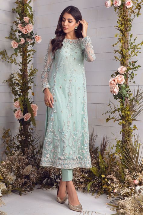 Cool & Breezy, this Aqua net A-line long shirt featuring delicate floral embroidery along with silver dabka, sequins, pearls, crystals and silk thread embroidery, pop of ferozi color to enhance the look. Paired with heavily embellished net dupatta and brocade straight pants, making this outfit a perfect choice for summer wedding festivities. Shirt Fabric: Net Shirt Length: 48” Pant Fabric: Brocade Dupatta Fabric: Net Shirt & Pant color: Bleached Aqua Dupatta Color: Ferozi Model is 5’6” and weari Net Suits Design Indian Straight, Net Suits Design Indian, Kurta Designs Women Casual, Net Kurti, Brocade Dupatta, Full Sleeve Gowns, Dress Design Pakistani, Fabric Brocade, Silk Thread Embroidery