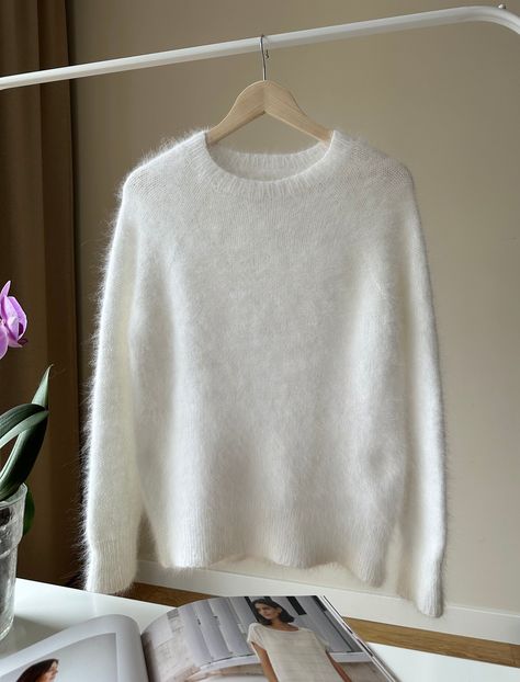 Features:  * 100 % Handmade  * Knit  * 80% Angora, 20% polyamide  The sweater is ready to ship today! Super soft and fluffy angora sweater is knitted of luxury Italian angora yarn. The angora sweater is practical, warm and soft. YARN - Italian Angora yarn,  - 80% Angora, 20% polyamide  COLOR - white   Size S/M, sweater measurements:  Length: 60 cm / 23,62" Width: 52 cm / 20,47" Bust Width:80-95cm / 31,49"- 37,40" CARE - hand wash only - with a special soap for wool - dry flat - do not bleach - do not iron All measurements are done by hand, so there may be an error of 2-3 cm.    Please be careful ! Due to your screen settings, there may be slight differences in the color tones / shadows of the photo and the actual item that you receive. Please contact me for more details. White Cashmere Sweater, Fluffy Sweater, Angora Sweater, Handmade Knit, Gap Sweater, Pullover Sweater Women, White Sweater, Soft Yarn, Handmade Knitting