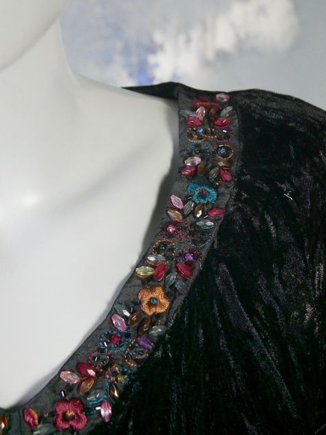 This stunning 1990s vintage pullover blouse has a V neckline edged in the front with a band of multicolor jewel beads and embroidered flowers. The upper front, sleeves, and back is a soft crinkled black crushed velvet fabric, and the middle part of the front has a paisley pattern crossover panel edged in black lace, and the midriff is a sheer crinkle pleated fabric. Bust = 34 inches (86.36cm) Shoulder Width = 15 inches (38.1cm) Waist = 30 inches (76.2cm) Hemline = 37 inches (93.98cm) Sleeve Length = 22 inches (55.88cm) Blouse Length = 25.5 inches (64.77cm) Brand label: F&2 Size: 6 US, 10 UK  Material: Polyester (but Dry Clean Only) Sourced in Madrid, Spain Condition: Excellent (clean, soft, and supple, with no stains, tears, wear spots, or weaknesses in the seams) --- DESCRIPTION ASSURANCE Crushed Velvet Top, Crushed Velvet Fabric, Vintage Pullover, Vintage Pullovers, Vintage Blouse, Velvet Top, Middle Part, Pleated Fabric, Blouse Length