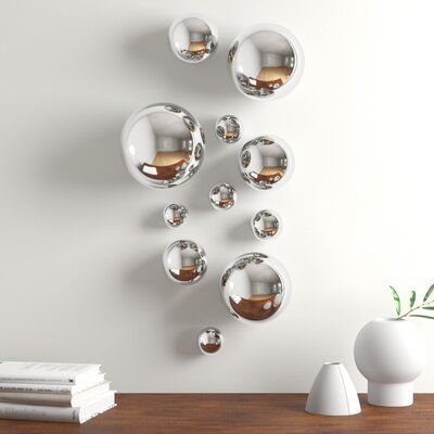Worldly goods too silver-plated wall spheres. Arrange these mirror-finished glass spheres in any way you choose, and the design will be uniquely yours. All our spheres are mouth-blown and as a result, have a hole where they came off the blowpipe. We use that hole to display them on a wall, and we now insulate the hole with rubber, to ensure a secure fit and protect your walls. And because it is hand-blown glass, recycled from tequila bottles & beer bottles, the glass is thicker, and a little hea Wall Spheres, Plate Wall Decor, Silver Walls, Geometric Wall Decor, Wall Decor Set, Flower Wall Decor, Geometric Wall, Modern Wall Decor, Mirror Wall Decor