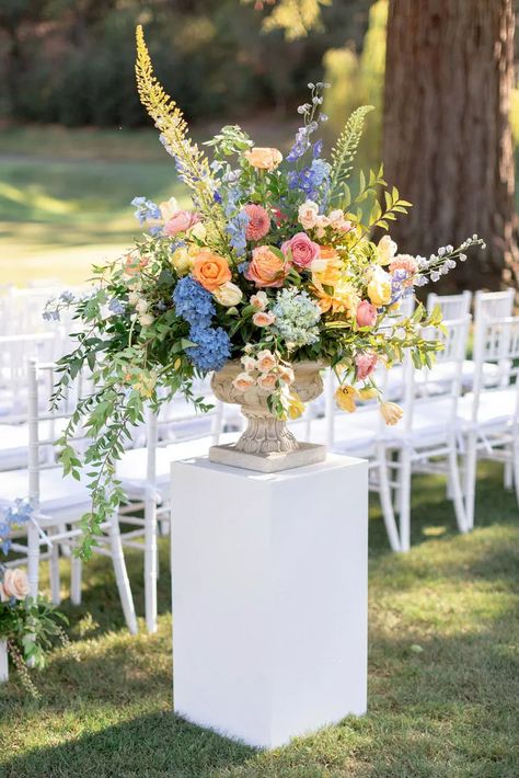 Colorful Aisle Flower Arrangement with Vase on Pedestal Pedestal Flower Arrangements, Diy Pedestal, Urn Arrangements, Deco Pastel, Flower Urn, Colorful Wedding Flowers, Aisle Flowers, Bright Wedding, Wedding Ceremony Flowers