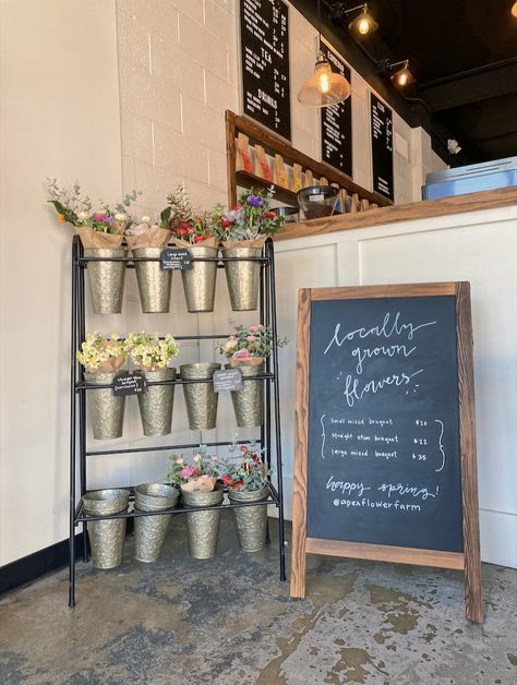 local flower stand in coffee shop. Flower Shop Stand Ideas, Coffee House Signage, Cafe And Gift Shop Ideas, Flower And Cafe Shop, Florist And Bakery Shop, Bakery With Flowers, Fresh Flower Display Stand, Flower Stand Market, Floral Restaurant Design