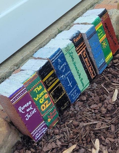 Bricks painted to look like books Bricks Painted As Books, Diy Brick Books, Paint Bricks To Look Like Books, Book Bricks Diy, Painting Bricks For Garden, Painted Bricks To Look Like Books, Painted Brick Books, Painted Garden Bricks, Garden Brick Books