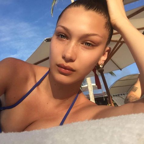 Bella Hadid posted this poolside selfie, and rocked no makeup-makeup like a pro. Models, Hoop Earrings