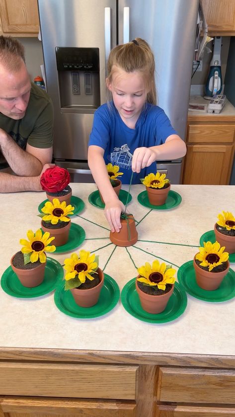 Don't pull the Wrong Flower 😂 | flower, entertainment, flowerpot | Don't pull the Wrong Flower 😂 Kids and family play fun spring table game with flower pots. Great outdoor game for spring. This video was produced by... | By Wonder and Raw | Facebook | Pull one. Pull one. Oh it's this one. This one right here. I'm sorry. Let's see. Let's see. There you go. Oh $10. Nice. $10. Nice. Your turn Kess. Pull a string. Pull one string. Oh it's that one. What it is? What is inside? What's inside? What c Reverse Raffle, Hat Games, Connect Group, Twister Game, Fest Ideas, Concentration Games, Flower Games, Flower Birthday Party, Flower Kids