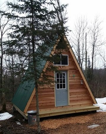 14x14 A-frame tiny cabin built from one of LaMar Alexander's plans A Frame Cabin Tiny House, Tiny A Frame House Plans, A Frame Diy Cabin, Tiny Cabin A Frame, Simple A Frame House Plans, Diy A Frame Cabin Floor Plans, A Frame Micro Cabin, Diy Tiny A Frame Cabin, Easy A Frame Cabin