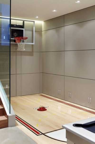 27 Indoor Home Basketball Court Ideas | Sebring Design Build Basketball Court Ideas, Basketball Themed Bedroom, Basketball Theme Room, Indoor Sports Court, Basketball Bedroom, Home Basketball Court, Indoor Basketball Hoop, Basketball Court Backyard, Basketball Room