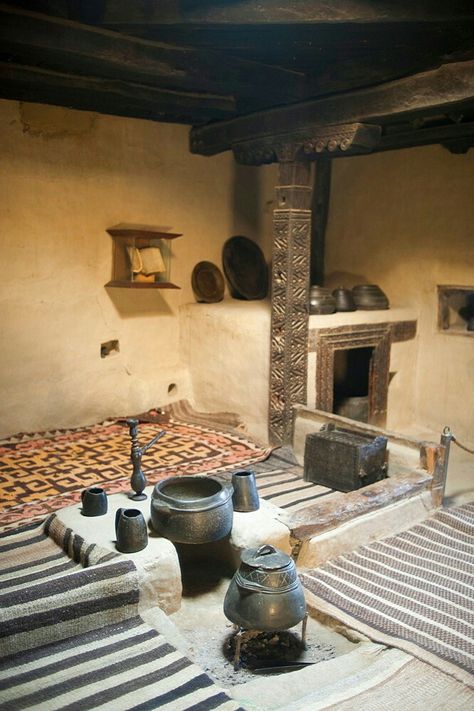 An ancient style kitchen with stone pots on display in a museum in the Hunza Valley, Gilgit-Baltistan, Pakistan. Ancient Home Design, Mud House Kitchen, Ancient Kitchen, Ancient Homes, Kitchen With Stone, Mud Houses, Hunza Valley, Ancient Houses, Indian House Plans