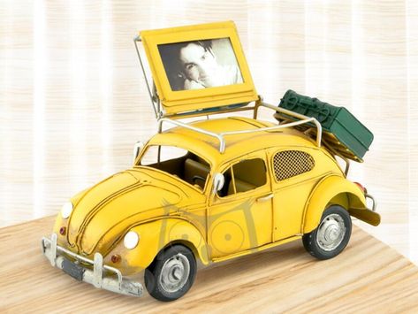 🚙 Capture Memories and Save in Style with our Vintage VW Beetle Piggy Bank with Photo Frame! This handcrafted, hand-painted masterpiece is more than just a piggy bank--it's a nostalgic tribute to the iconic Volkswagen Beetle, designed to add a touch of retro charm to any space. Made entirely from hardened metal, this unique piece features a functional piggy bank and a hidden photo frame beneath the roof rack. Perfect for lovers of the 1960s, VW Beetle fans, and anyone who appreciates vintage decor, this versatile item is as practical as it is stylish. 🏁💰 ✨ Why You'll Adore This Vosvos: Handcrafted Excellence: Made from durable, hardened metal, each piece is carefully crafted and painted by hand, ensuring a unique finish. Functional Design: The piggy bank offers a fun way to save, while Vw Beetles, Vintage Vw Beetle, Bank Photo, Vintage Vw, Capture Memories, Vw Beetle, Volkswagen Beetle, Roof Rack, Functional Design