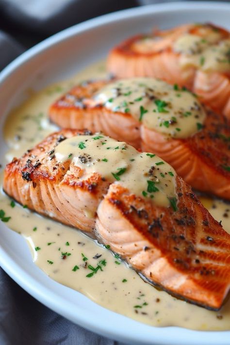 Looking for the perfect sauce for your salmon dishes? Look no further! Whether you're grilling, baking, or pan-searing your salmon, these delicious sauce ideas will elevate the flavor and take your meal to a whole new level. From easy and tangy lemon dill sauce to creamy hollandaise sauce, we've got you covered. Don't forget to try our mouthwatering teriyaki glaze or zesty garlic butter sauce. Salmon Drizzle Sauce, Creamy Garlic Butter Baked Salmon, Salmon Presentation Ideas, Easy Salmon Sauce, Butter Dill Sauce For Salmon, Good Sauce For Salmon, Creamy Garlic Butter Salmon, Salmon With Sauce Recipes, Best Recipe For Salmon