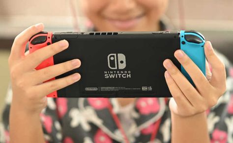 The 8 Best Nintendo Switch Games The Entire Family Will Love - Filter Free Parents Holding Switch Reference, Playing Nintendo Switch Pose Reference, Person Playing Nintendo Switch Pose, Holding Nintendo Switch Reference, Playing Nintendo Switch Pose, Visual Drawing, Best Nintendo Switch Games, Drawing Library, Mario Party Games