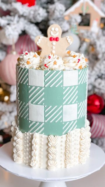 C R Y S T A L | CAKE DESIGNER on Instagram: "Sweater + plaid cake 🎄 . Hands downs, obsesseeeeeeddd! When I first had this idea in mind, in knew it had to be a soft GREEN! So festive! . White plaid on a green buttercream base, made with a stencil! Bordered with sweater-like knitting using different piping tips and stable white buttercream. Topped off with the most adorable Christmas sprinkles with mini gingie men and candy canes, mini branches, and the cutest gingerbread man cookie! . Going back to a few Christmases ago and forever obsessed 🎄 . #trending #reels" Different Piping Tips, Plaid Cake, Green Buttercream, Sweater Plaid, White Buttercream, Christmas Sprinkles, Trending Reels, Gingerbread Man Cookies, Piping Tips