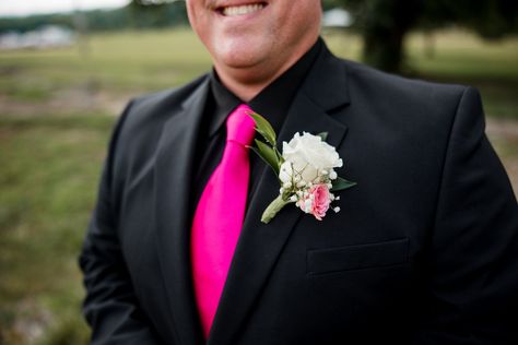 Grooms, listen up. You can add a pop of color to your wedding day attire. This groom rocked an all-black suit with a hot pink tie and boutonniere to match the brides bouquet. | John Myers Photography & Videography All Black Suit With Pink Tie, Black Suit Pink Tie, Pink And Black Suit, All Black Tux, Homecoming 2024, Hot Pink Tie, John Myers, Pink Boutonniere, All Black Suit