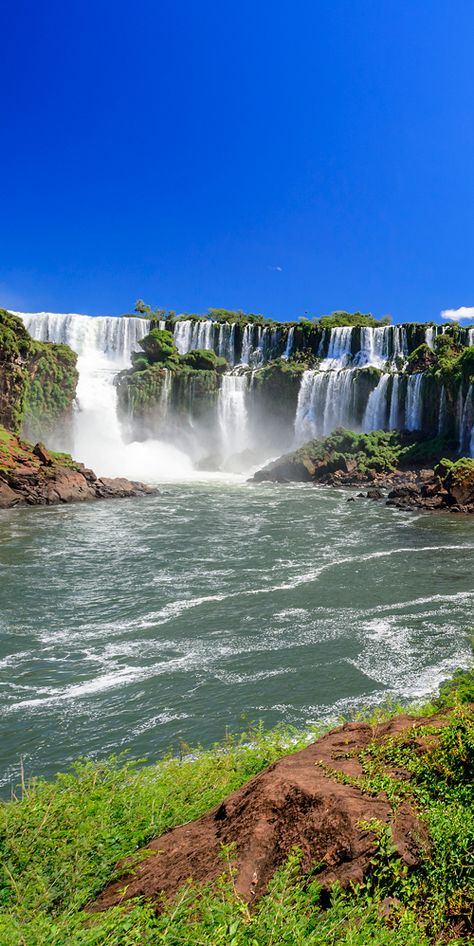 One of the world's most incredible waterfalls, Iguazu Falls sits on the border of Brazil and Paraguay #waterfall Photos Of Waterfalls, Water Falls Beautiful Waterfalls, Waterfalls Pictures, Brazil And Argentina, Landscape Waterfall, Waterfall Scenery, Waterfall Pictures, Matka Natura, Iguazu Falls