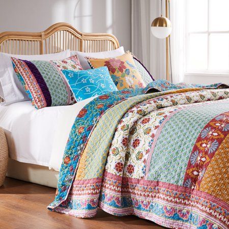 Rows of vivid medallions, stylized florals and geometric prints create distinctive bohemian styling. The Tori reversible quilt set features mitered borders and multi-fabric construction embellished with velvet bands.  Reverses to a coordinating updated floral print on a Caribbean blue ground.   Face 95% cotton with 5% polyester velvet embellishment; back and fill 100% cotton. Oversized for better coverage on todays deeper mattresses.  Machine quilted with fabric bound edges for durability and su Patchwork, Teal Pillows, Cotton Quilt Set, Geometric Prints, Cotton Bedspread, Caribbean Blue, Gold Pillows, Floral Quilt, Bedspread Set