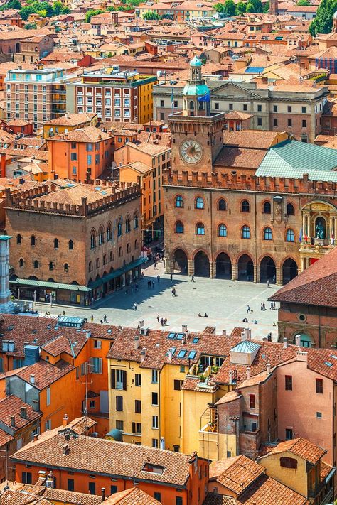 Image taken from above of a square in Bologna surrounded by terracotta rooftops behind in Emilia-Romagna, Italy. Emilia Romagna Italy, Places To Visit In Italy, Modena Italy, Bologna Italy, Italy Travel Tips, Italian Culture, Emilia Romagna, Food And Wine, Sustainable Travel
