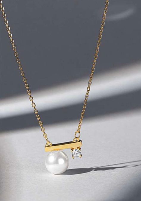 This simple yet elegant gold bar cz diamond Pearl necklace is made with 14K gold and a dainty high quality CZ diamond.    It is light weighted and so dainty that goes perfectly with every kind of your outfit.  ❤️Order $35 USD to get free standard shipping in US. DETAILS : * 14K solid gold natural freshwater pearl dainty gold zircon necklace.   * Necklace Dimension: app. 40cm + 5 cm extension.   * Elegant Design: 14K Solid Gold Natural Pearl pendant necklace, perfect for adding a touch of elegance to any outfit. * Materials:  14K gold, natural freshwater pearl. * Style: Minimalist and elegant. All purchase comes with a gift ready jewelry box or pouch.  HOW TO CARE FOR YOUR JEWELRY 🪄🪄All plated jewelry (14K / 18k gold plated) has a coat to help from tarnishing; however, to further help pre Diamond Pearl Necklace, Tiny Pearl Necklace, Zircon Necklace, Pearl And Diamond Necklace, Gold Pearl Necklace, Gold Diamond Necklace, Tiny Diamond, Natural Pearl, Pearl Pendant Necklace