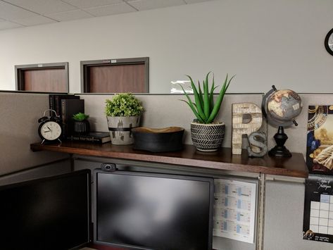 Simple shelf brackets from hardware store with red oak board stained in dark walnut and various shelf decor items. Organisation, Bank Teller Desk Decor, Office Shelf Decor Workspaces, Dark Cubicle Decor, Cubicle Decor Boho, Zen Desk Decor, Team Office Space Ideas, Office Desk Decor For Work Cubicle Boho, Diy Cubicle Shelf