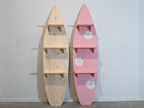 Wooden Surfboard with 3 attached shelves in baby pink color with hibiscus flowers.  Dive into coastal charm with our Wooden Decorative Surfboard featuring functional flair. Available in both clear, unpainted simplicity and a delightful baby pink hue adorned with three charming hibiscus flowers, this surf-inspired shelf unit adds a touch of beachside elegance to any space. Crafted from high-quality FSC Pine wood, the clear version serves as a versatile blank canvas for your creativity or a minima Fake Surfboard Decor, Flower Room Ideas Bedrooms, Surfboard Key Holder, Surfboard Display Ideas, Hawaiian Themed Room, Shelf Painting Ideas Diy Wood Shelves, Surf Board Shelf, Hibiscus Flower Decor, Surfboard In Room